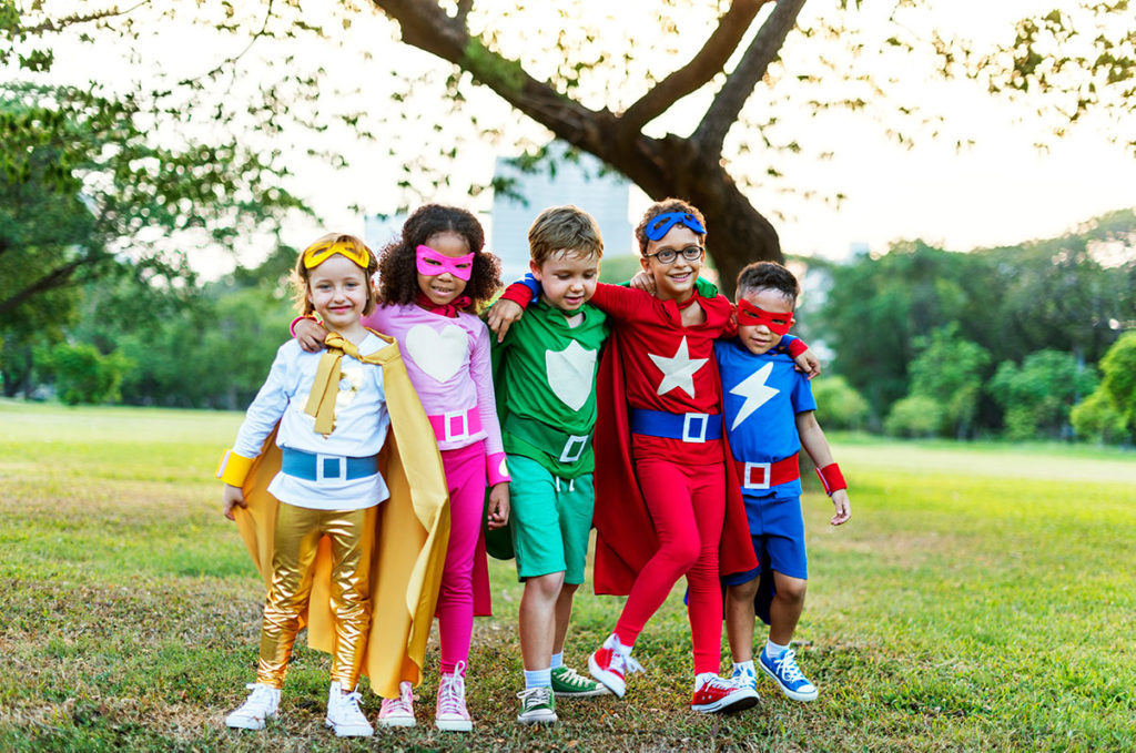 Superheroes kids playing outside